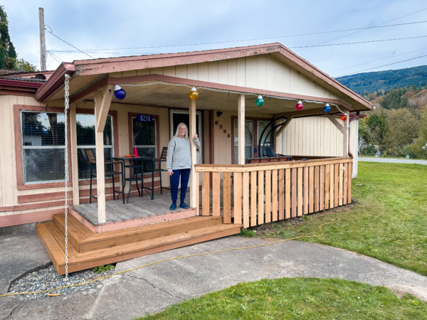 Denise, a participant in Skagit Habitat for Humanity's Critical Repair Program standing on her recently repaired porch.