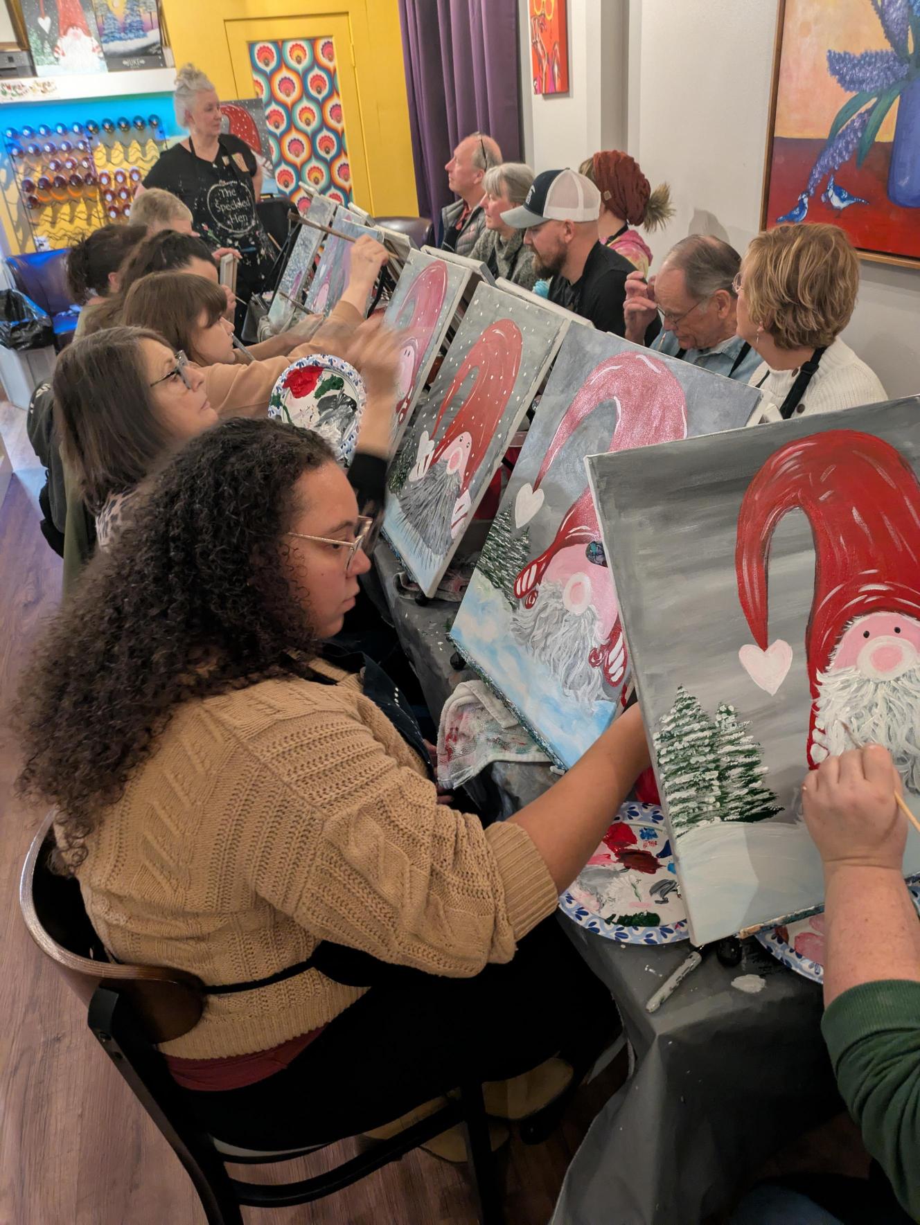 Attendees working on their paintings